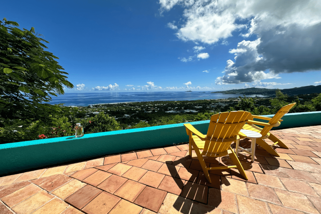 Casa de Vista View with Yellow Adirondack Chairs